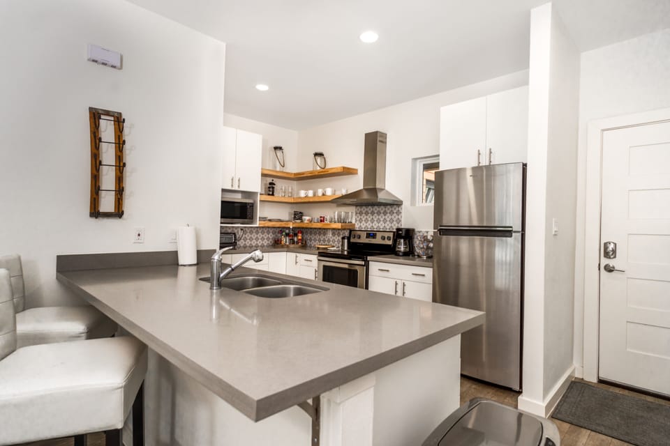 Full stocked Kitchen; stove, refrigerator, microwave, coffee maker pots and pan.