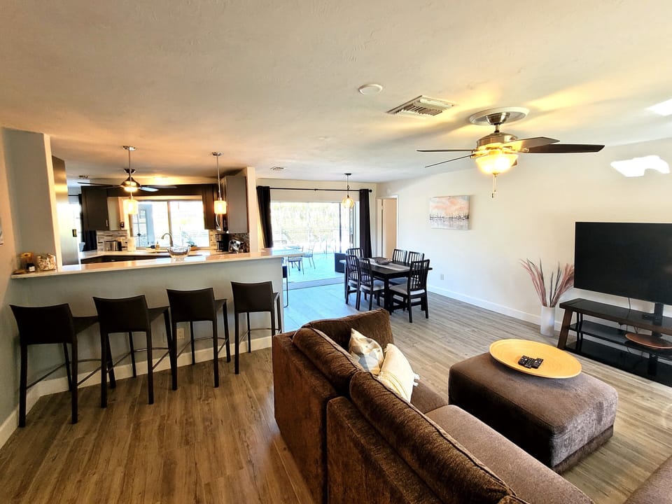 Living room 1, dining room and kitchen bar, sliding door to patio.