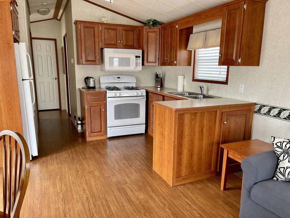 Fully stocked kitchen with kettle, toaster, pots and pans and cutlery