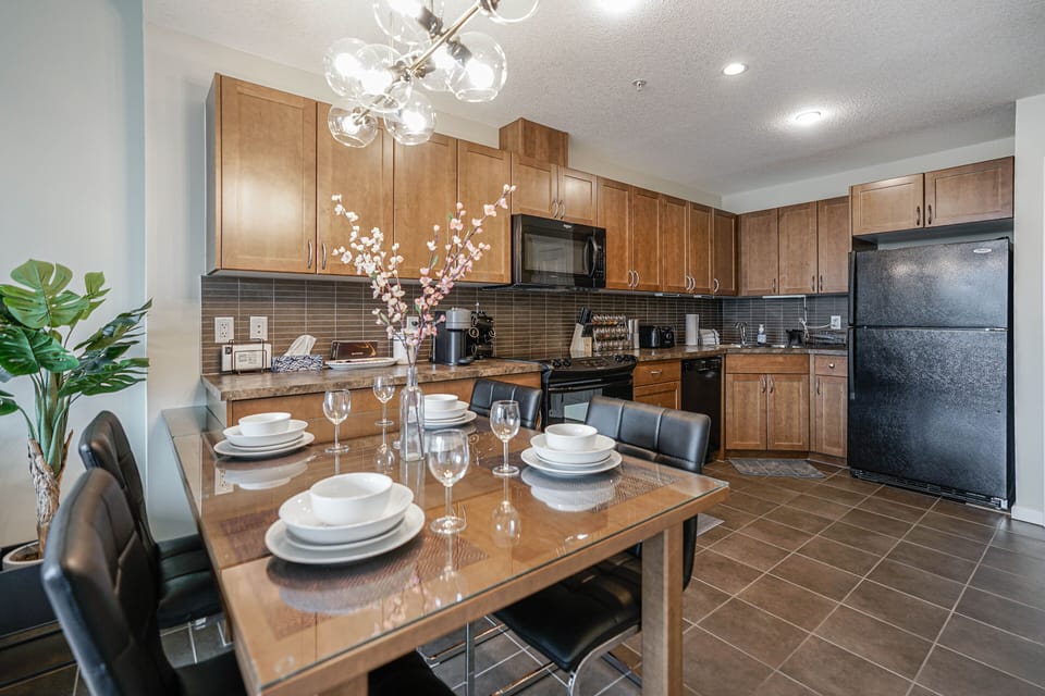 Full kitchen with an assortment of appliances, cookware, dinnerware, glassware