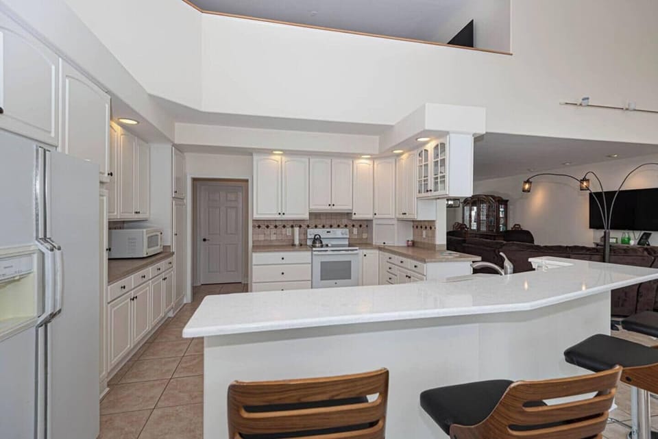LLarge fully equipped kitchen with ample counter space, modern appliances, and everything you need to prepare meals during your stay.