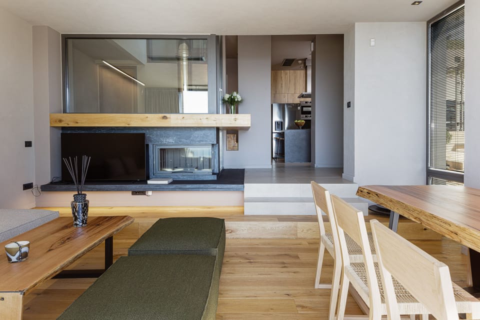 The effortlessly chic and luminous lounge area wraps around the modern fireplace!