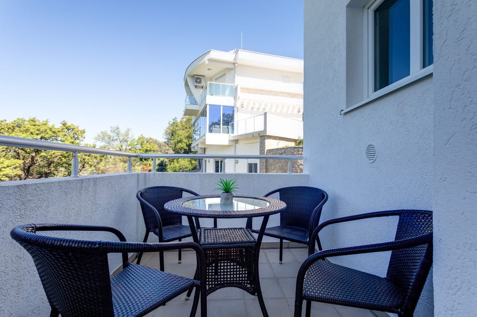 Spacious balcony with outdoor furniture