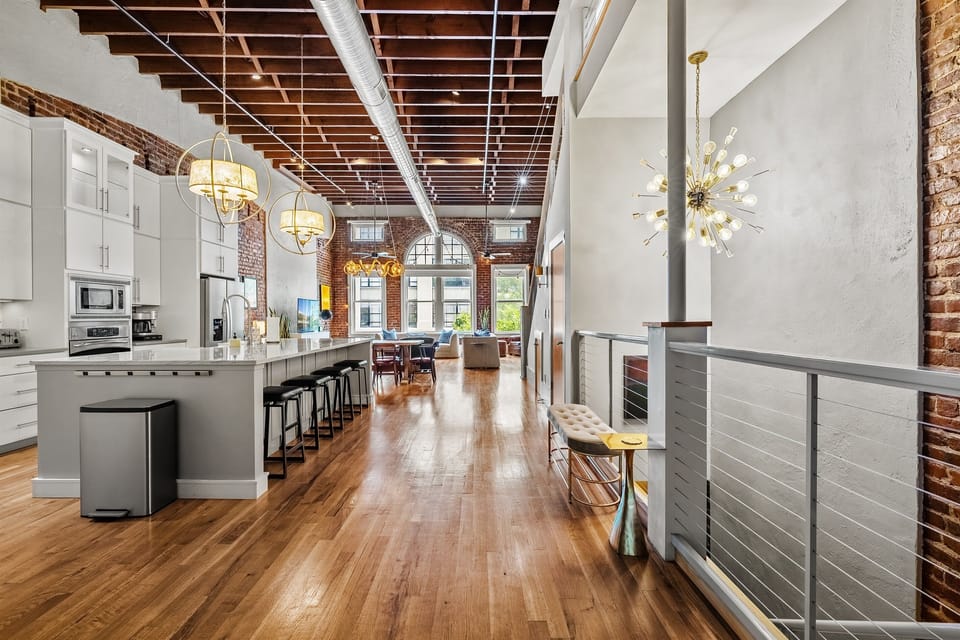 Fully equipped chef’s kitchen with granite countertops and bar seating.