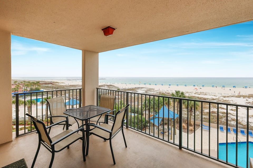 Enjoy meals or morning coffee on the balcony, with stunning views of the beach and pool area just below