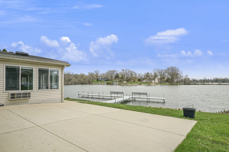 Patio with dining table and seating.  Large lawn for games and activities