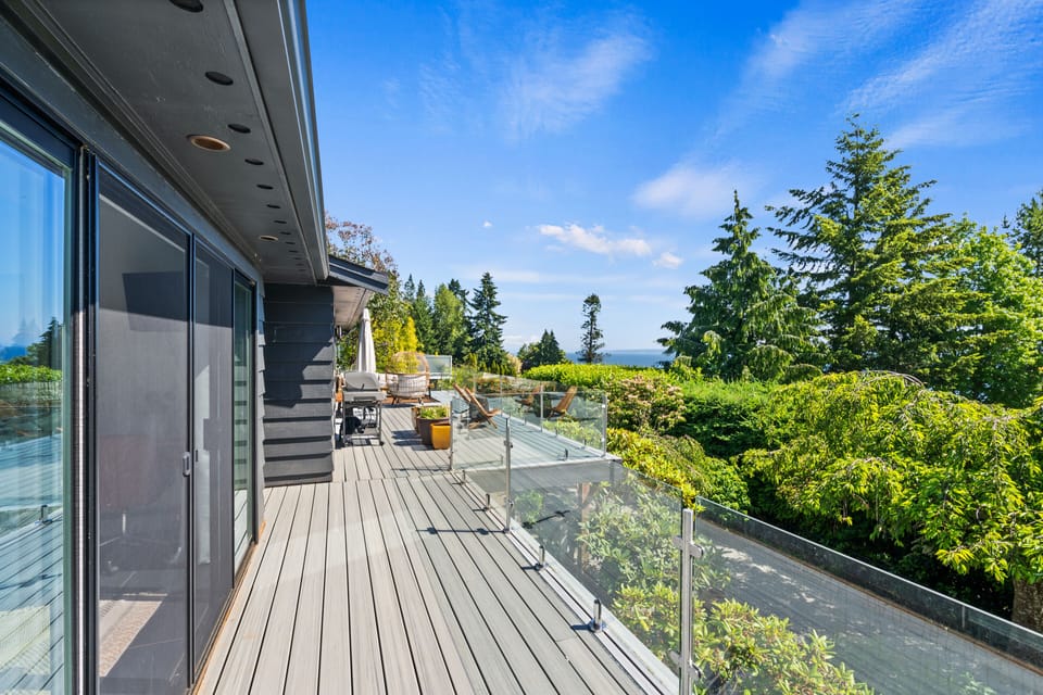 Large deck with lounge area, picnic table, grill, and plenty of seating.