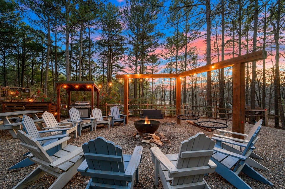 A cozy escape in the heart of the woods—warm fire, open sky, and pure serenity.