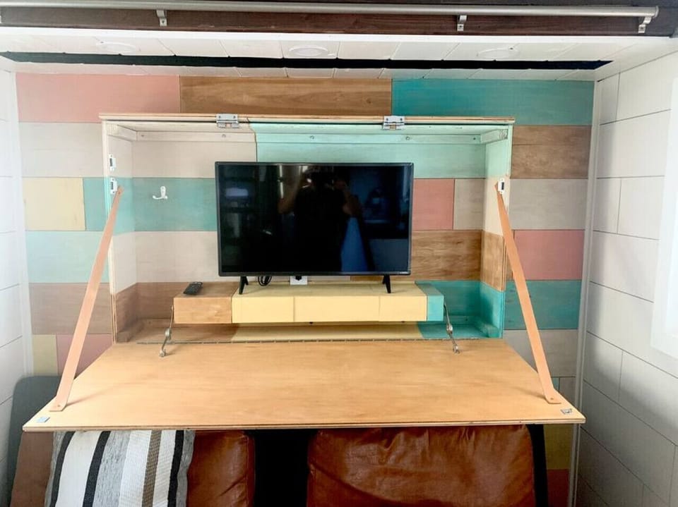 TV inside hidden shelf agains north wall