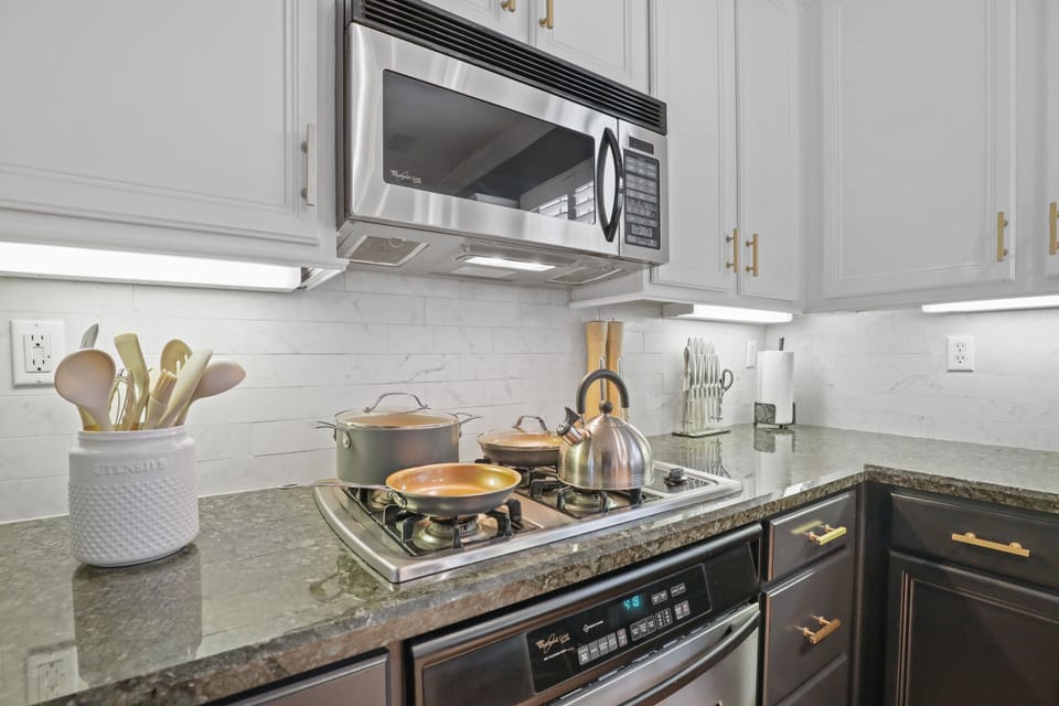 The kitchen features a gasoline stove, stainless steel microwave and dishwasher.