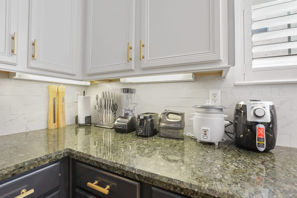Kitchen equipped with Air Fryer, Rice Maker, Blender, Mixer, & Toaster.