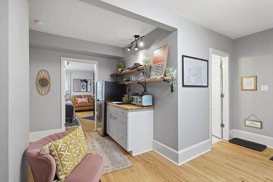 A bathroom is to the right of the entry door as you enter the living room. 