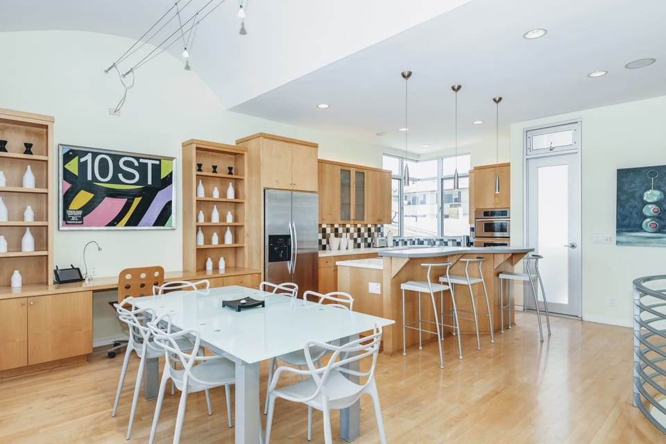 Open concept Dining and Kitchen area with island and stainless steel appliances.