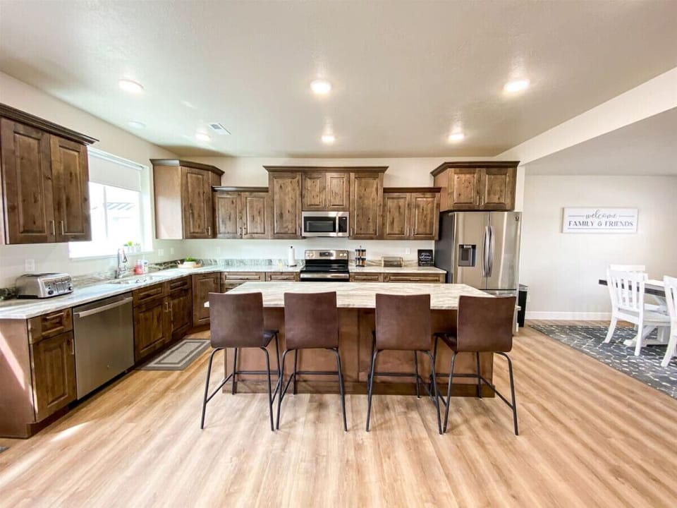 Spacious kitchen with rustic charm, modern appliances, and ample seating for shared meals and memories.