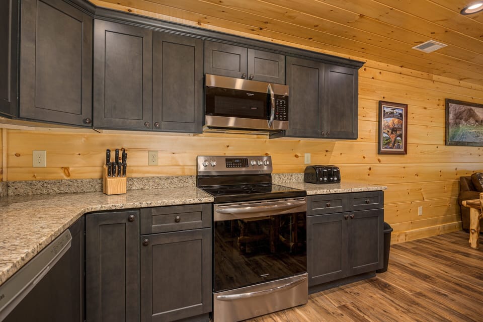 Beautiful kitchen has a drip coffee maker, k-cup coffe maker and small appliances as well as dishes, silverware, pots and pans and a crock pot