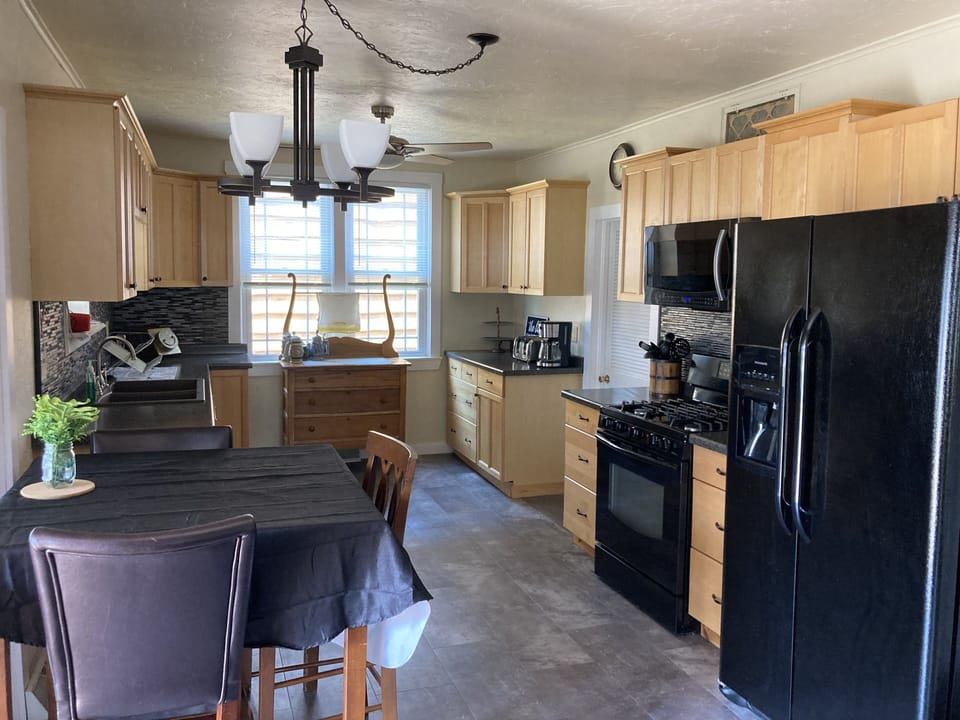 Another view of the kitchen and kitchen table. The patio is directly left.