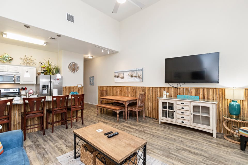 Relax in your open-concept living space with bamboo accents, vaulted ceilings, and coastal charm perfect for memorable vacation moments.