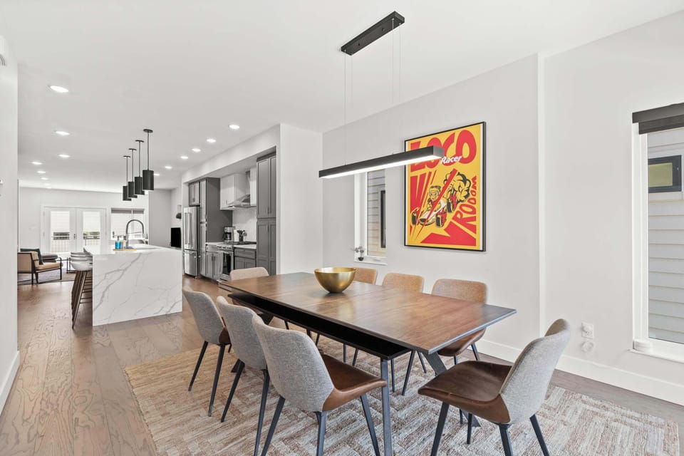 Spacious dining area with seating for the whole group, conveniently located next to the chef's kitchen and oversized island.