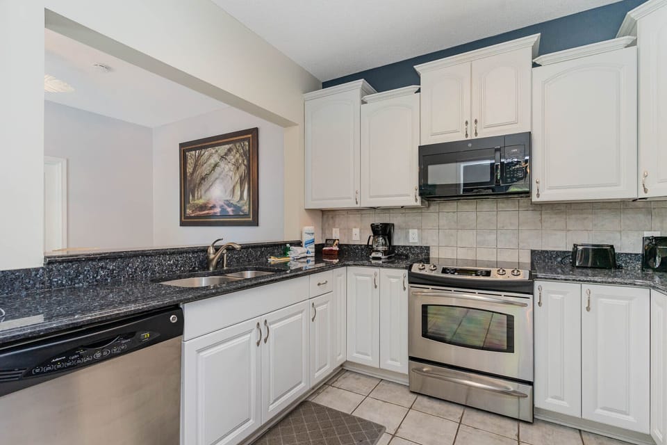 Kitchen - The modern kitchen has all stainless steel appliances, granite counters and re-faced cabinets.