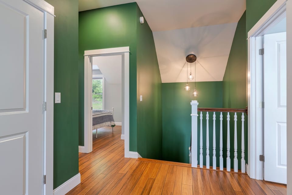 The upstairs landing connects three bedrooms, two full bathrooms and the office