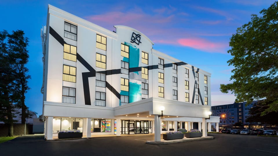 Arrive to a striking, art-forward exterior glowing at sunset.