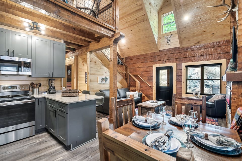 View from the back door, looking into the kitchen, dining and living room with the loft above.