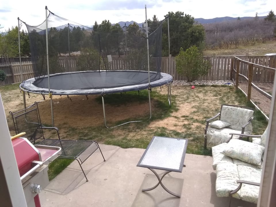 Fenced in back yard; grill; sitting area. Trampoline can go or stay.