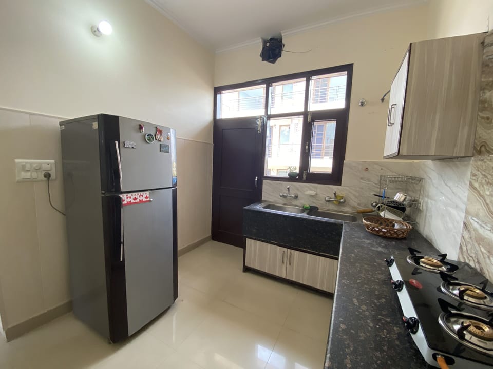 A full-size fridge, double sink & access to the back terrace.