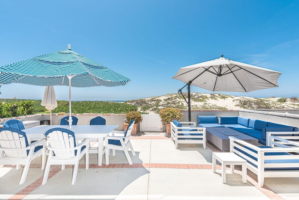 You'll want for nothing in this bright and cheery beachfront home located on the most idyllic stretch of sand in Newport.
                