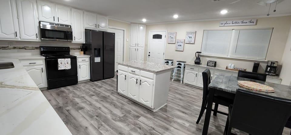 Modern kitchen with vinyl floors, quartz  countertop and stainless appliances
