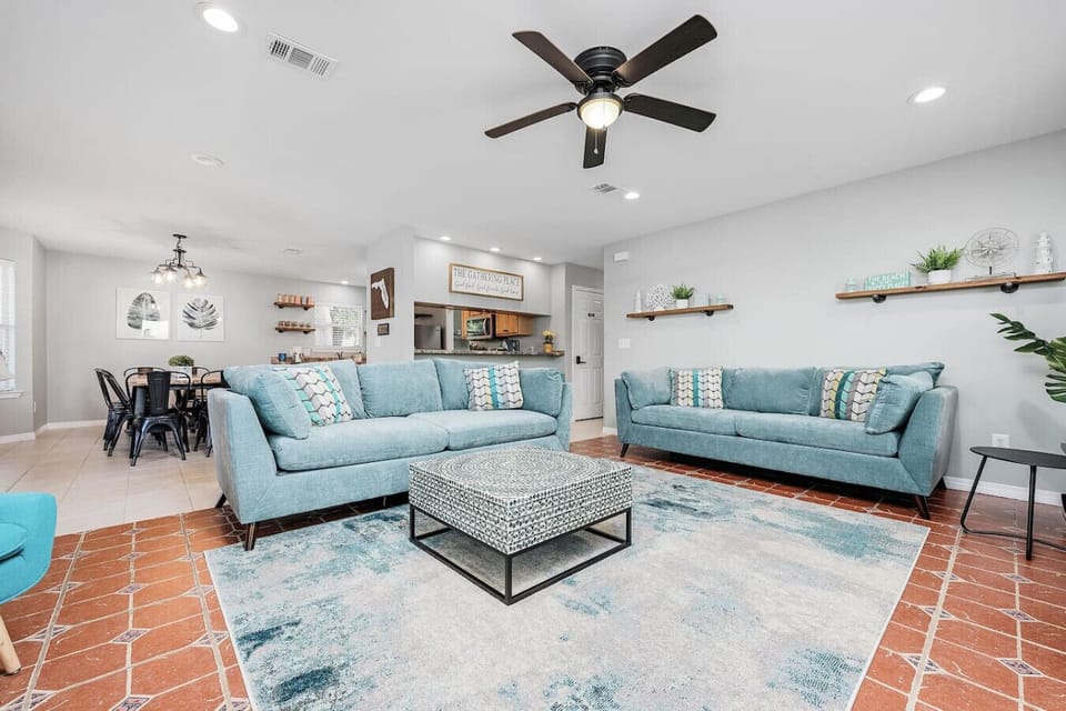 Cabana Life Beach House has a large living room with two oversized couch/sofas, one pullout sofabed, a warm heating electronic fireplace, ceiling fan, additional seating, seaside decor, and a 65 inch HD TV for movie night!