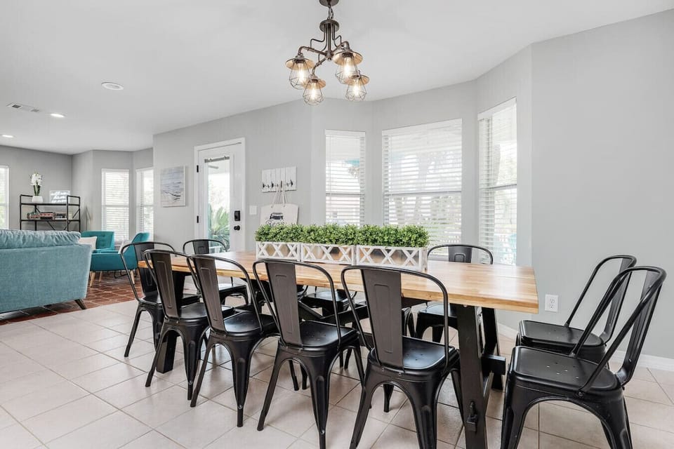 Cabana Life Beach House has a large custom made wood dining table that easily seats 12 guests at a time with a large open floorplan.