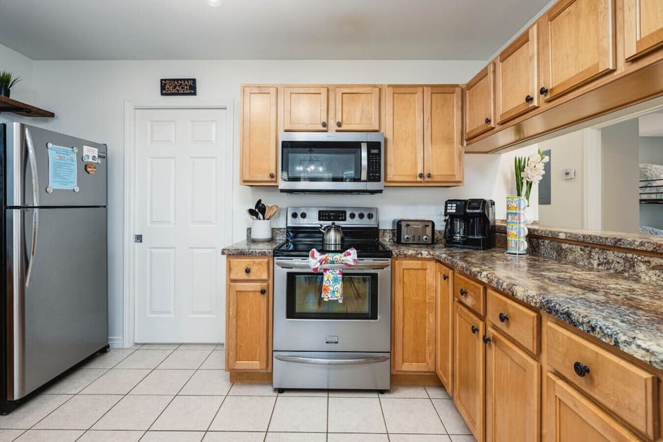 A large kitchen has  dripcoffee and K-cup, creamer/sugar supplied. Pots, pans, utensils, and spices for cooking are available. Fully equipped with toaster, toaster oven, air fryer, and modern stainless steel appliances, and plenty of counter space.