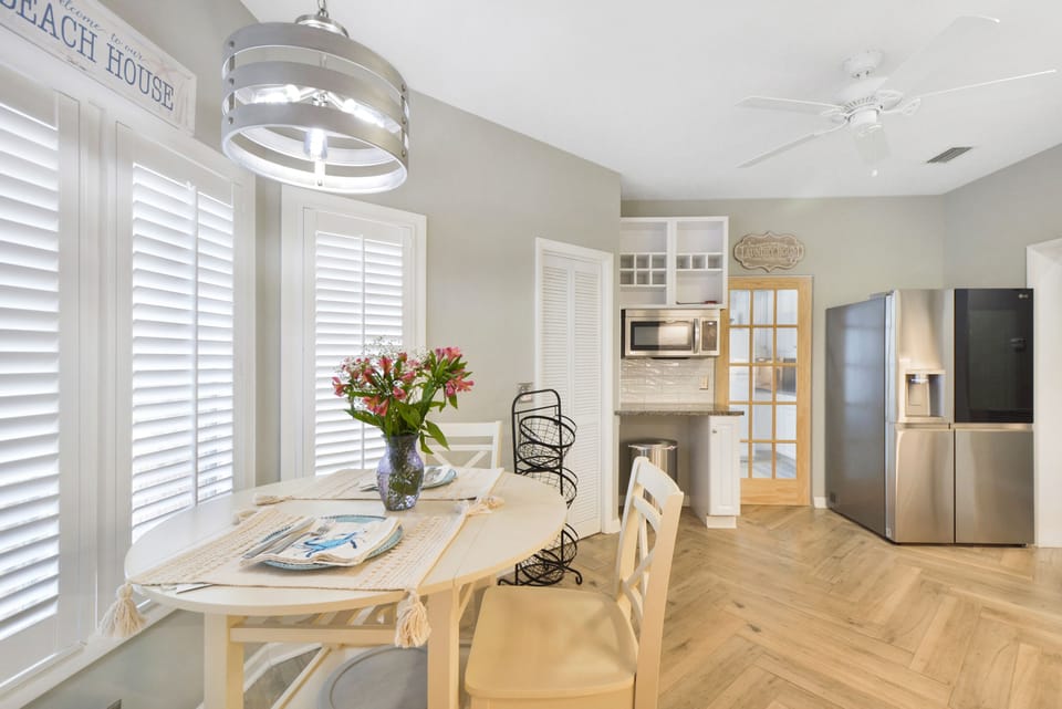 Eat-In Kitchen with Sunny Bay Windows - Start your day under soft island light with this eat-in breakfast nook, just off the kitchen. Fuel up before a bike ride to Ocean Motion or a shopping trip through Redfern Village, less than 3 minutes from your door.