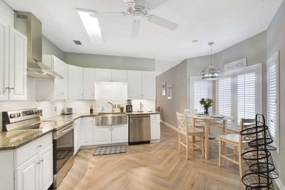 Full Kitchen + Dining Table for Four - A fully equipped kitchen with granite countertops, Keurig and Cuisinart coffee makers, and seating for four—just minutes from grocery runs at Harris Teeter or takeout from Porch, Iguanas, or Georgia Sea Grill.