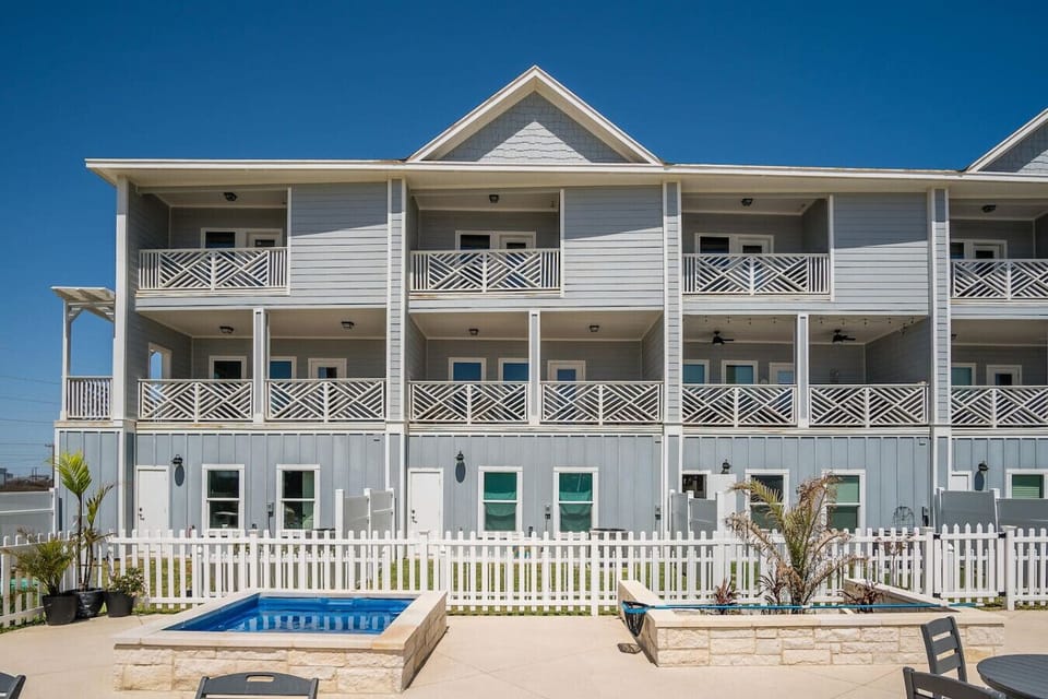 Charming coastal retreat — spacious and serene with wraparound balconies just steps from the shore.