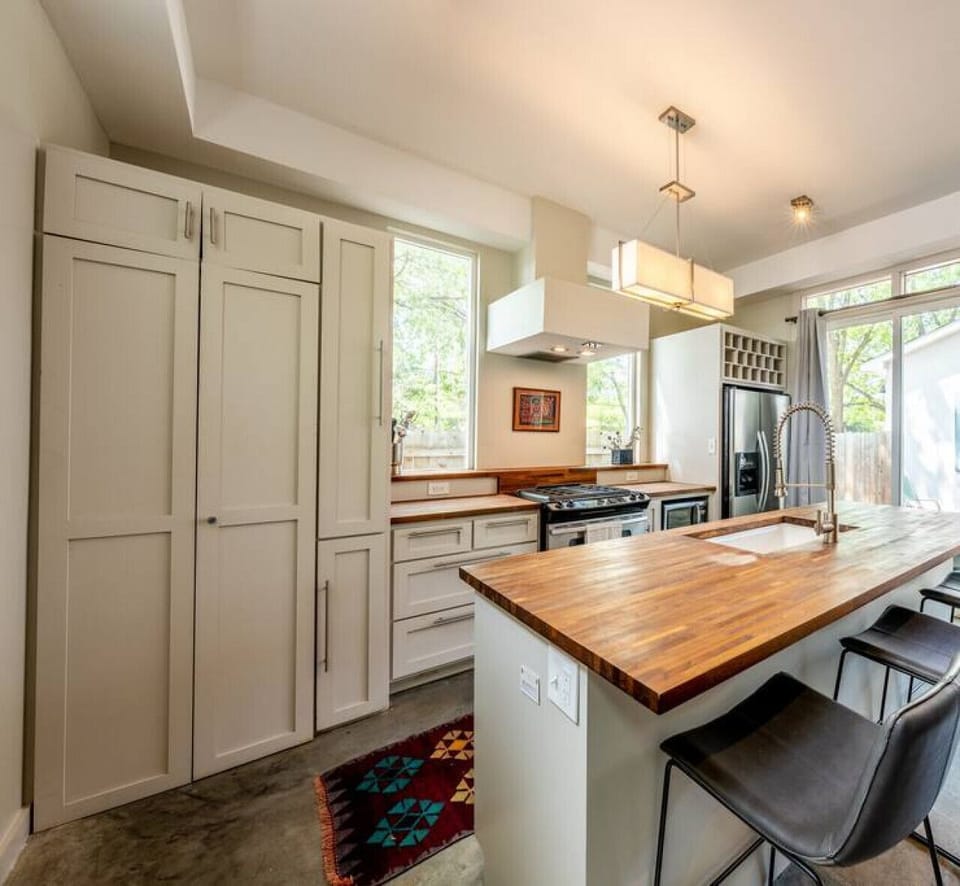Stackable laundry is behind the tall cabinet