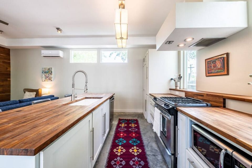 Stove, large sink, microwave, fridge and stackable laundry washer and dryer