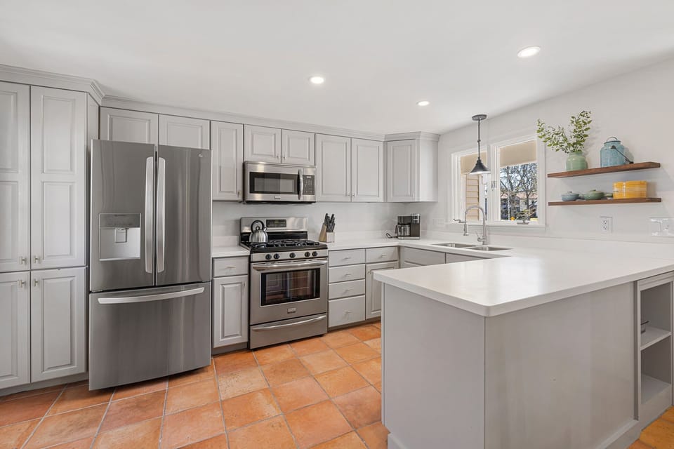 Fully equipped kitchen with modern appliances and Keurig coffee machine.