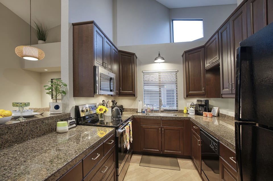 The open kitchen with plenty of storage and all new  black appliances 