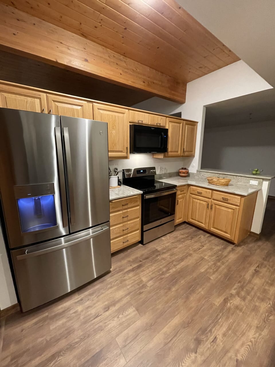 Full kitchen with new stainless steel appliances and fully stocked .