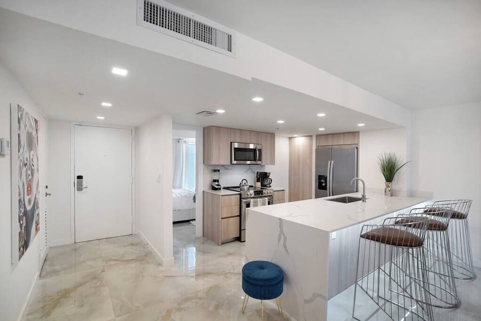 Fully equipped kitchen, front entry, view of 4th Jr size bedroom off kitchen. 