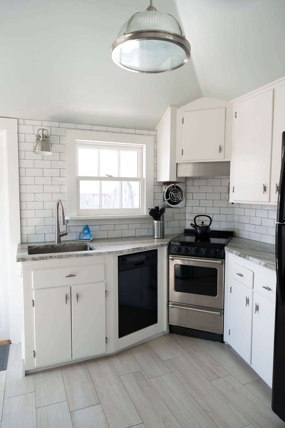 Kitchen with dishwasher, stove, full size fridge