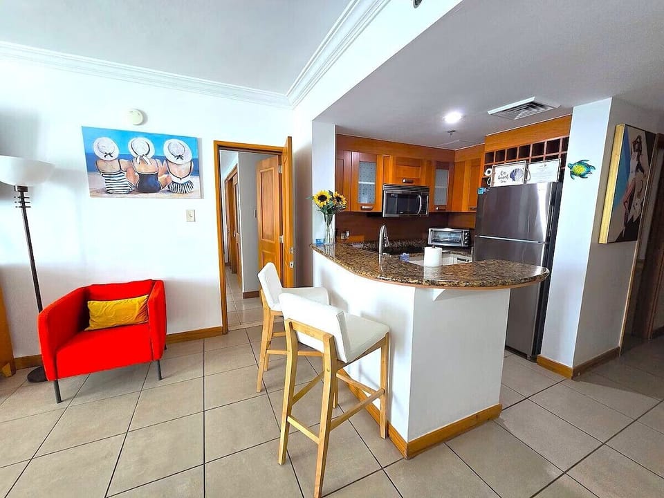 To the left side of the kitchen is the door that leads to other room. 