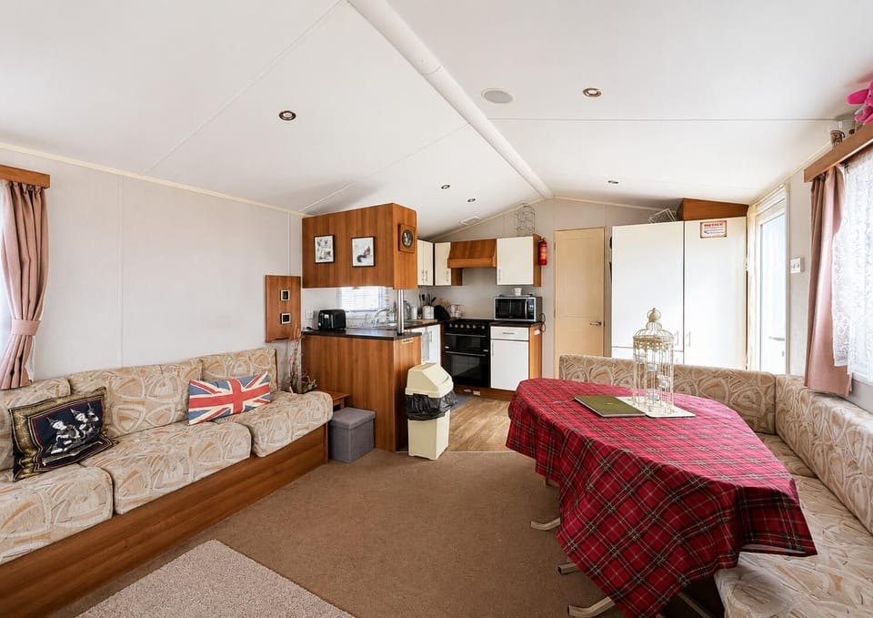 The curved bench seating provides space for everyone to gather comfortably after a day of exploring Felixstowe beach. Whether you’re settling in for a movie night or sharing stories, this inviting layout creates the perfect central hub for making memories