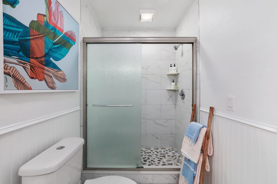 Walk-in shower in the primary ensuite—clean, bright, and refreshing after beach days