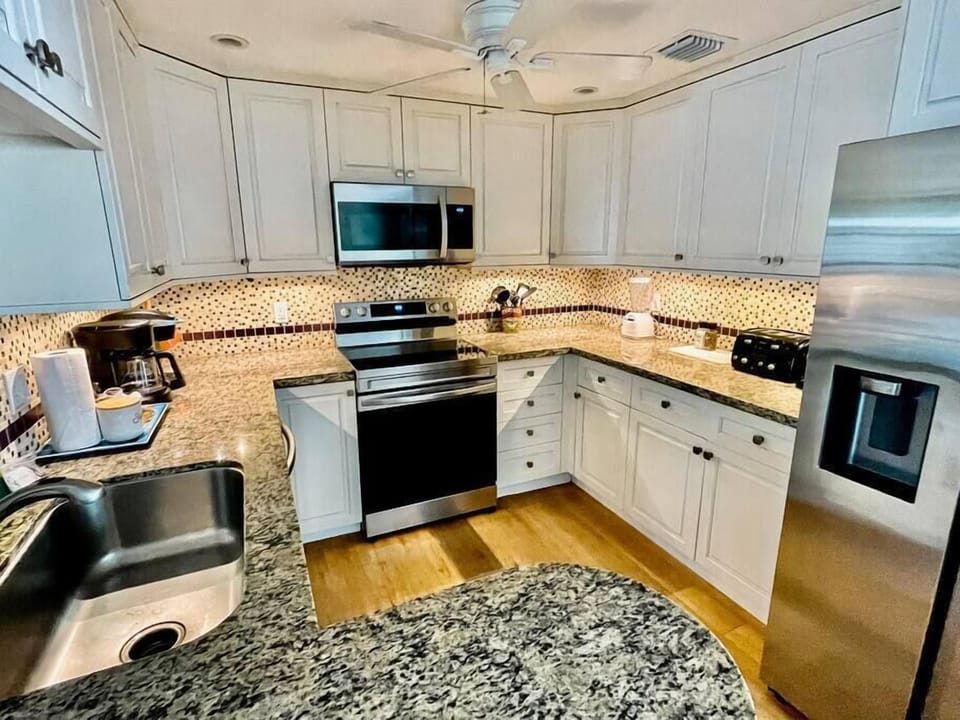 Kitchen is equipped for making drinks or making a meal. 