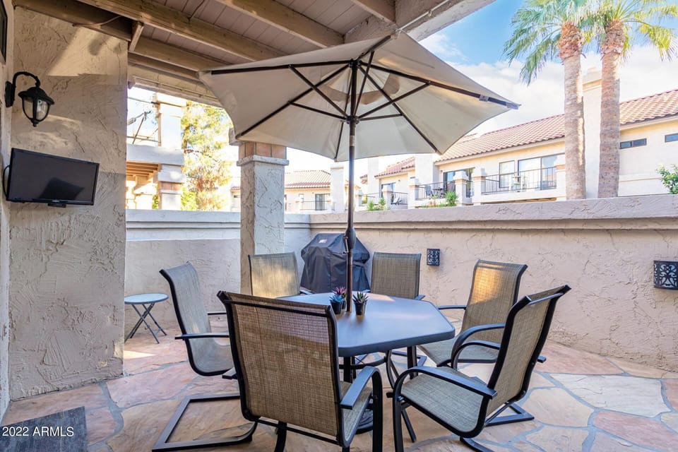 Downstairs patio off of dining area.  TV with satellite cable & Weber BBQ