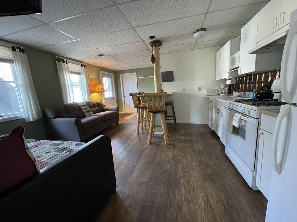eat -n kitchen with bar top and bar stools