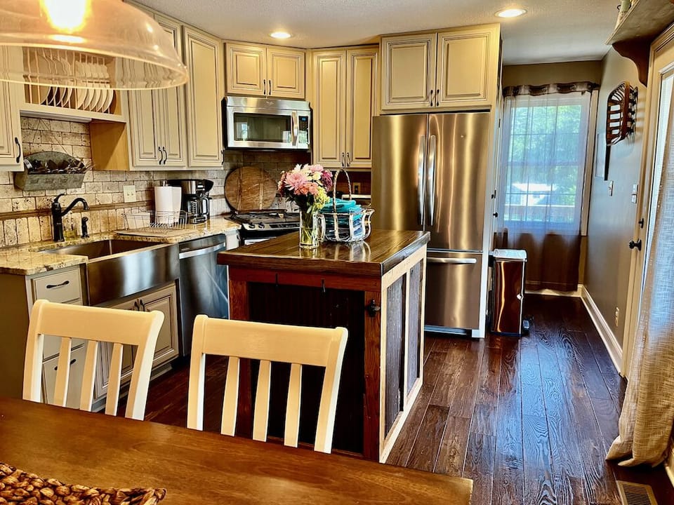 Full kitchen with dining table, microwave, stove top, toaster oven, dishwasher. 